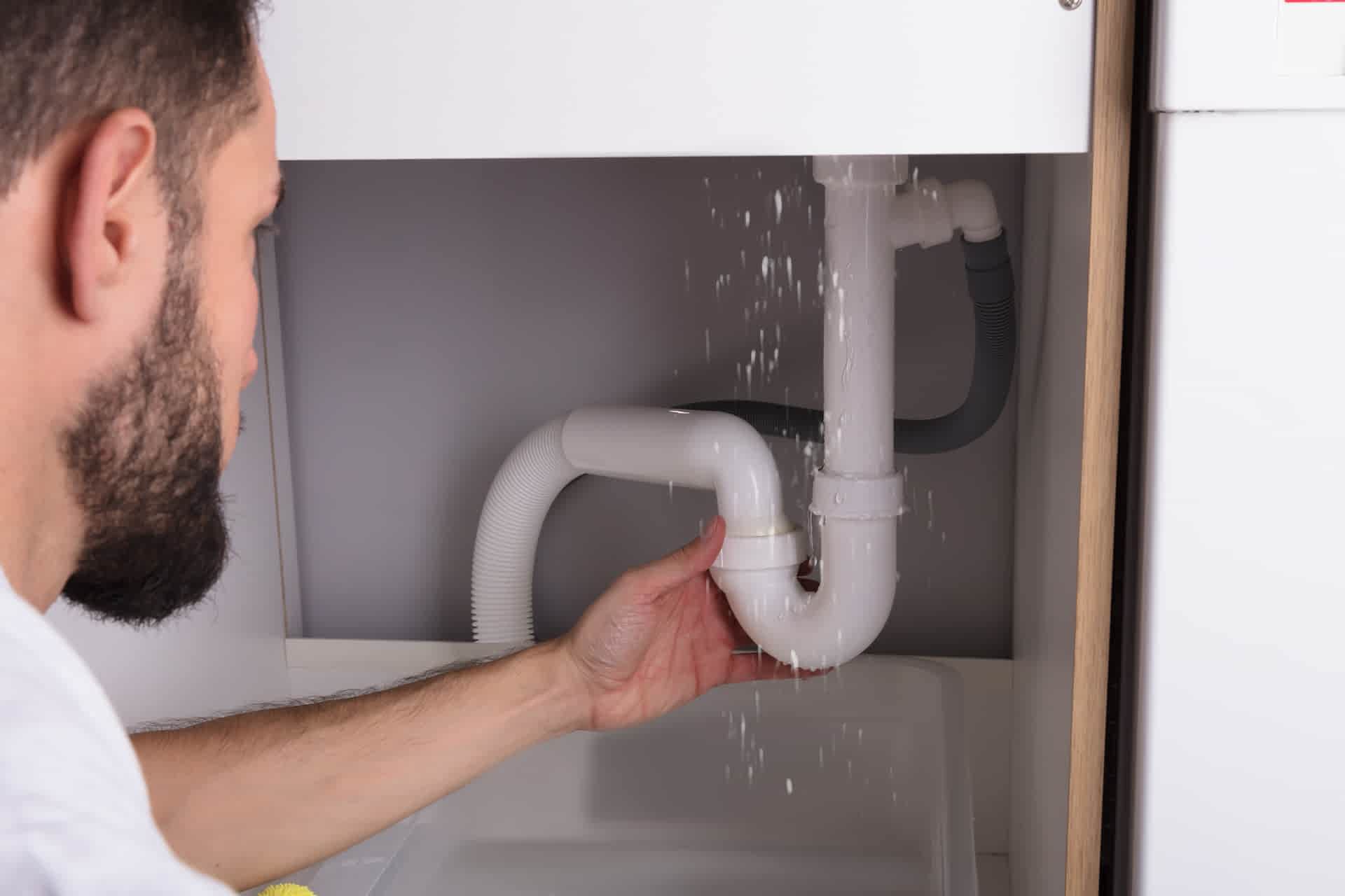 Under-sink plumbing leak causing water damage inside a home