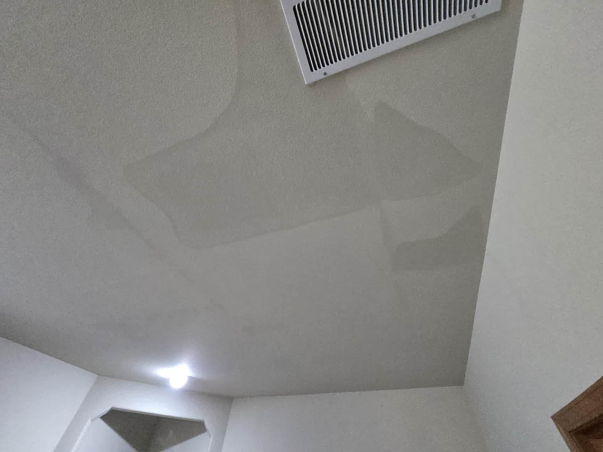 Water staining across an interior ceiling caused by water intrusion.