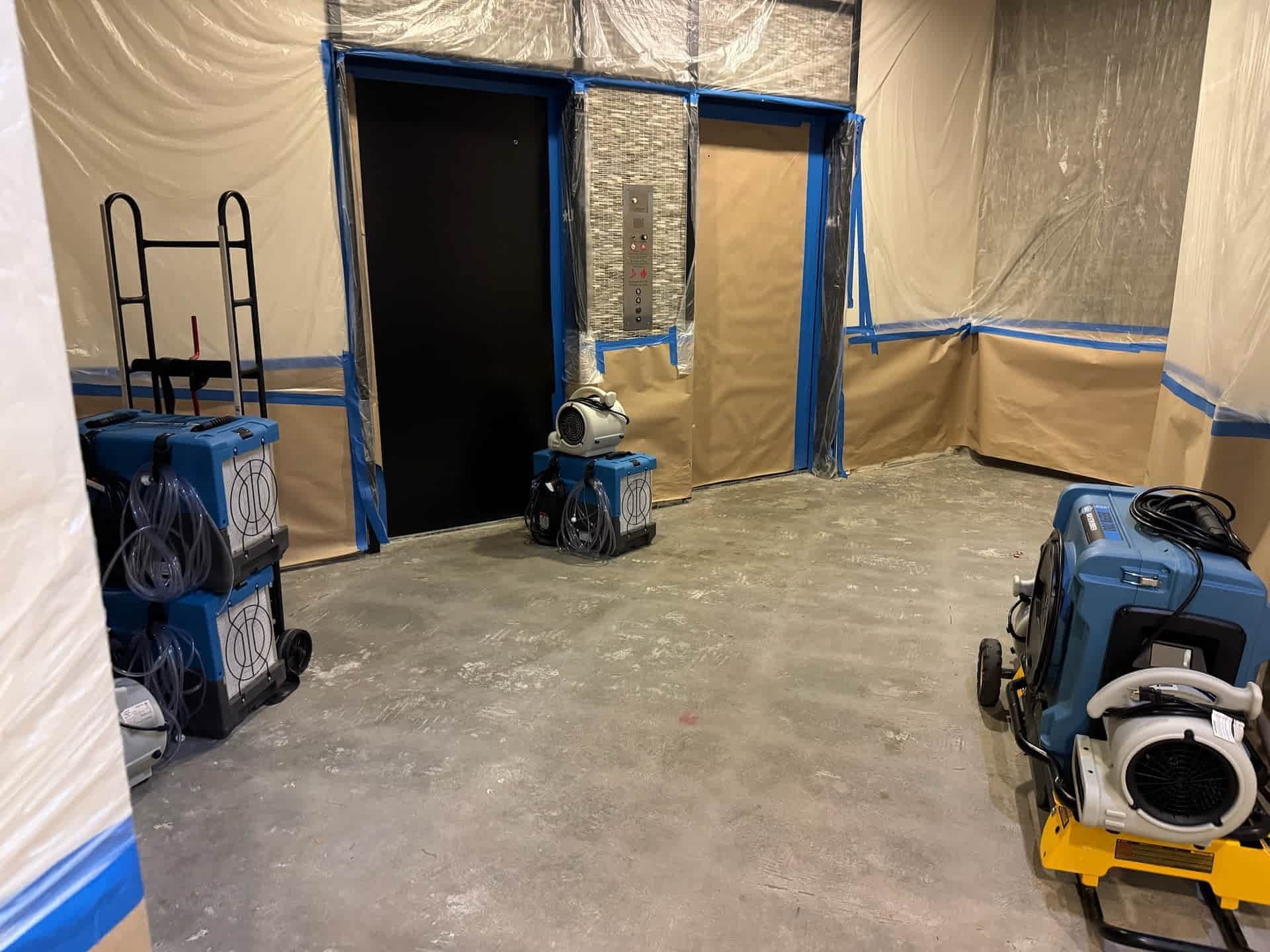 Commercial water damage drying equipment and containment during structural drying.